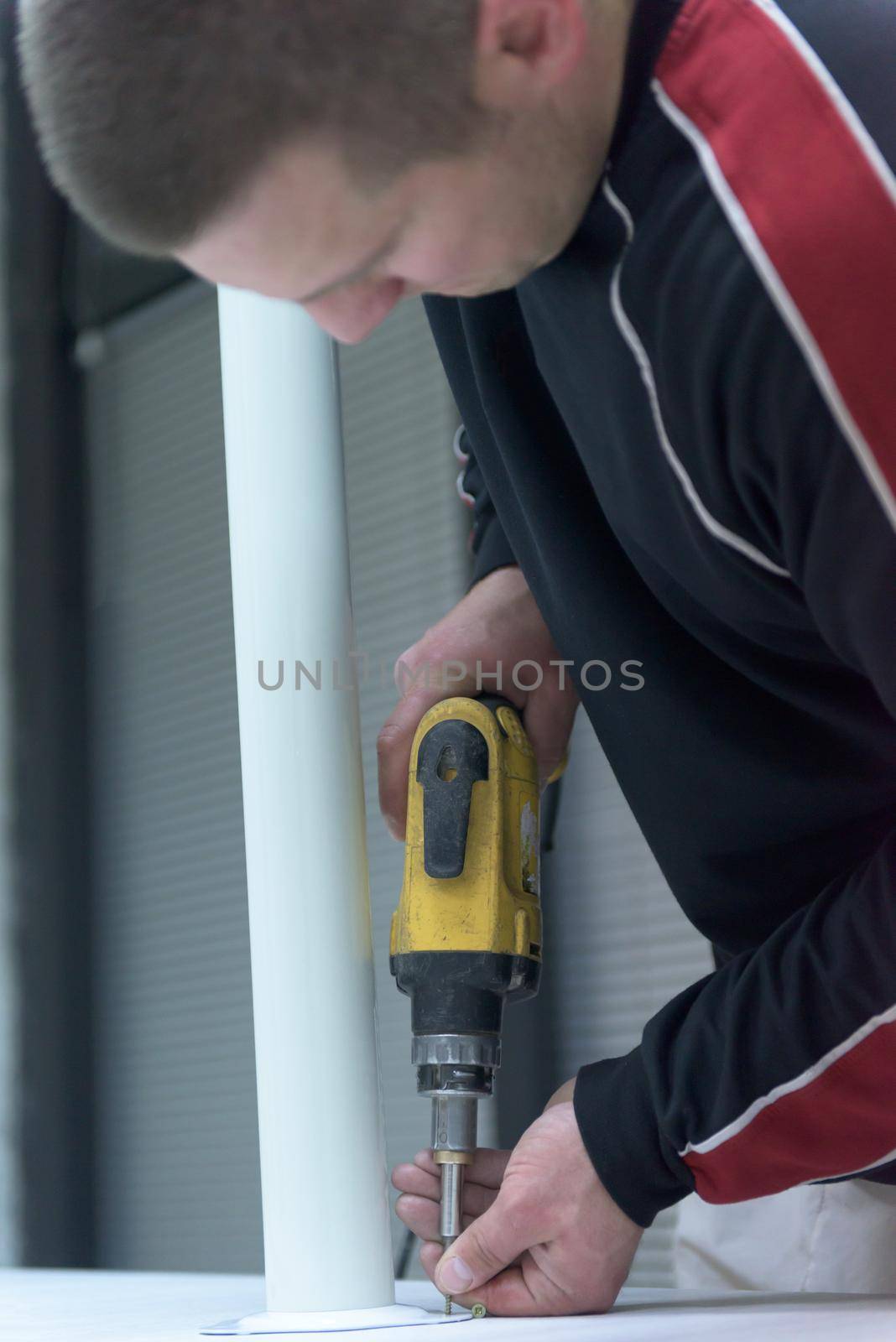 repairman working with drilling machine by dotshock