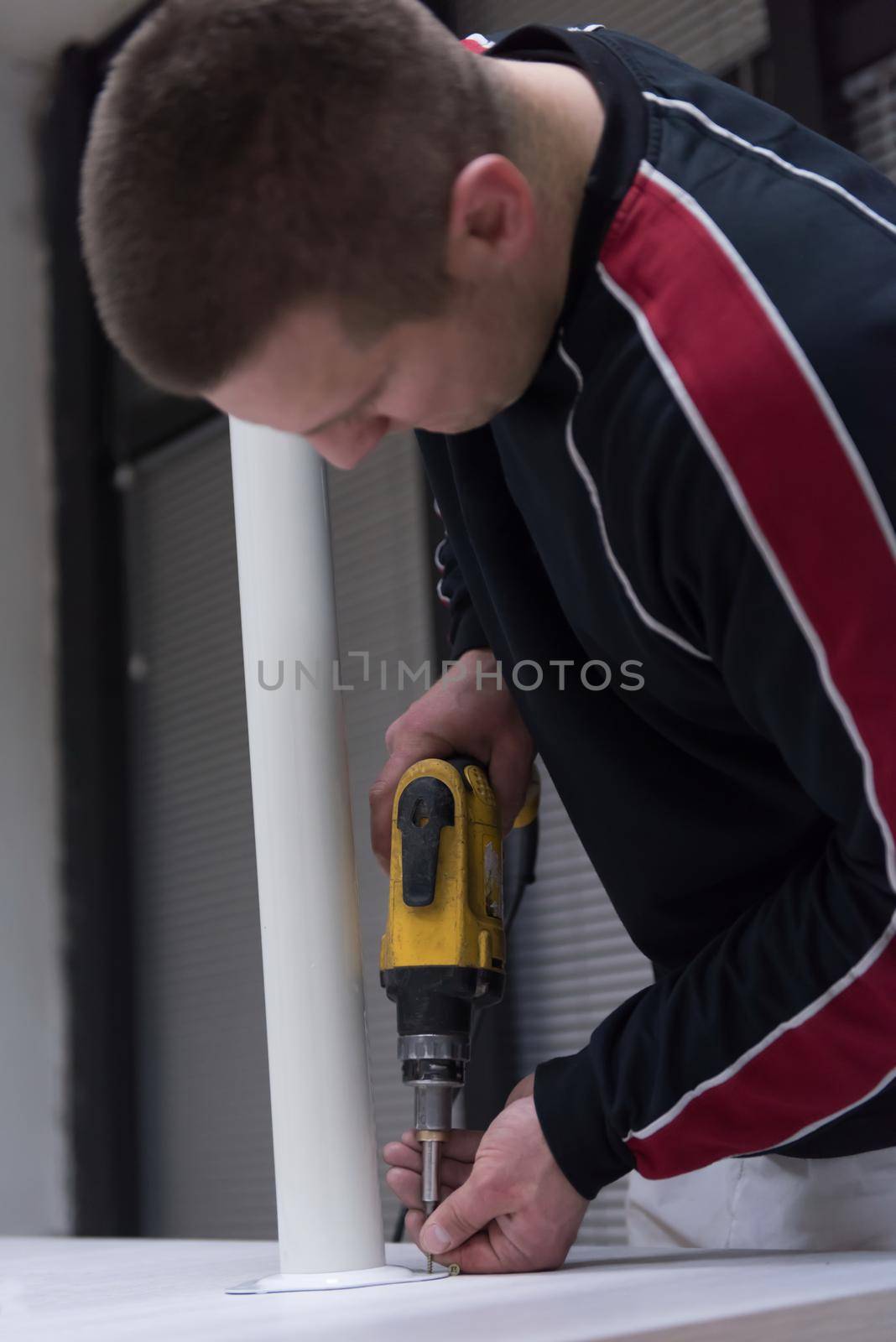 repairman working with drilling machine by dotshock