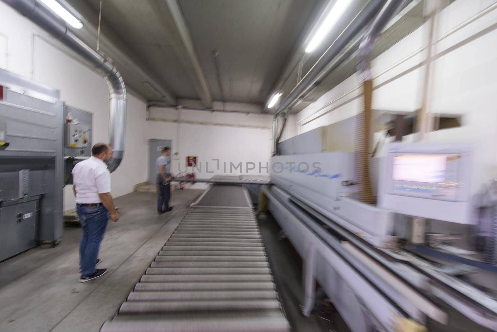 two worker working in a factory for the production of wooden furniture