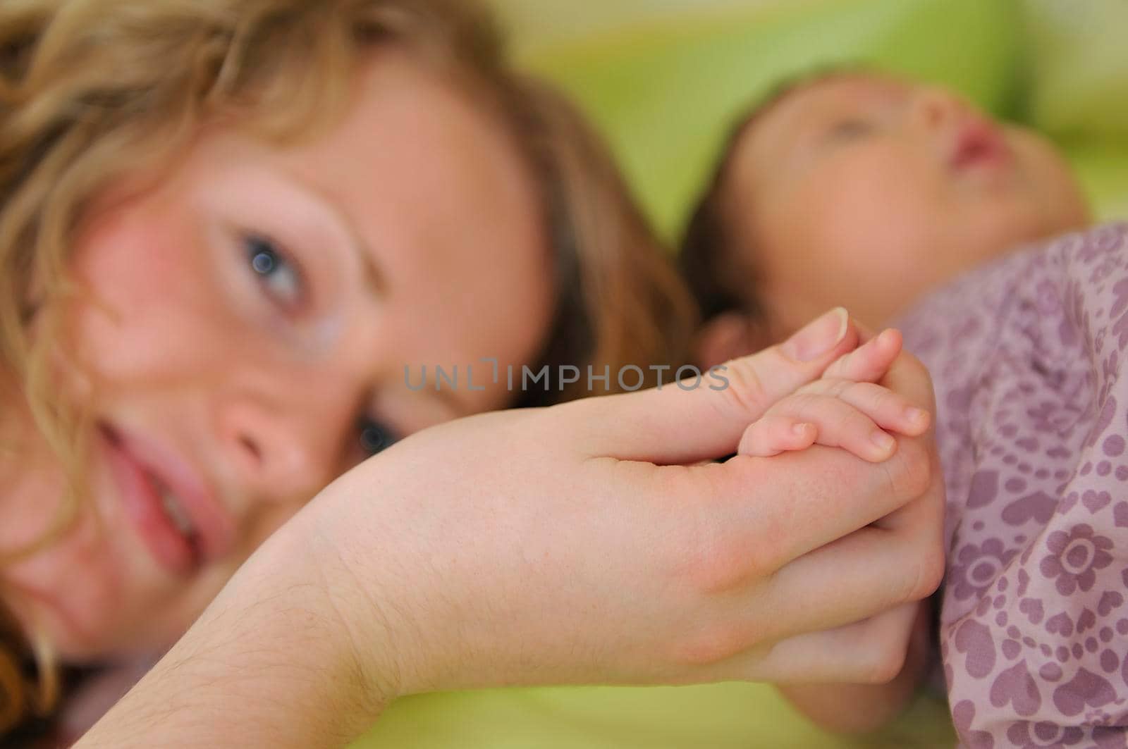 beautiful young mother hold small children hand