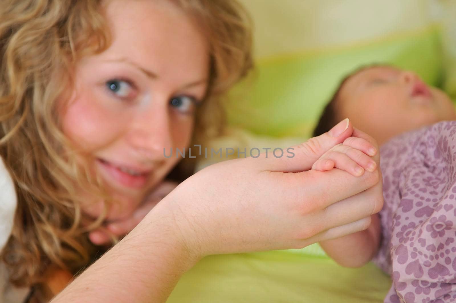 beautiful young mother hold small children hand