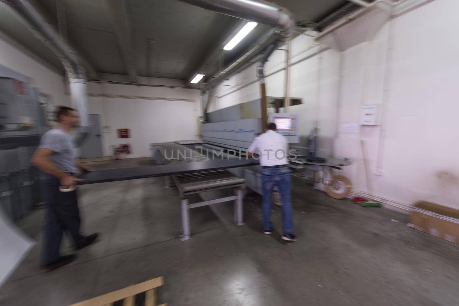 two worker working in a factory for the production of wooden furniture