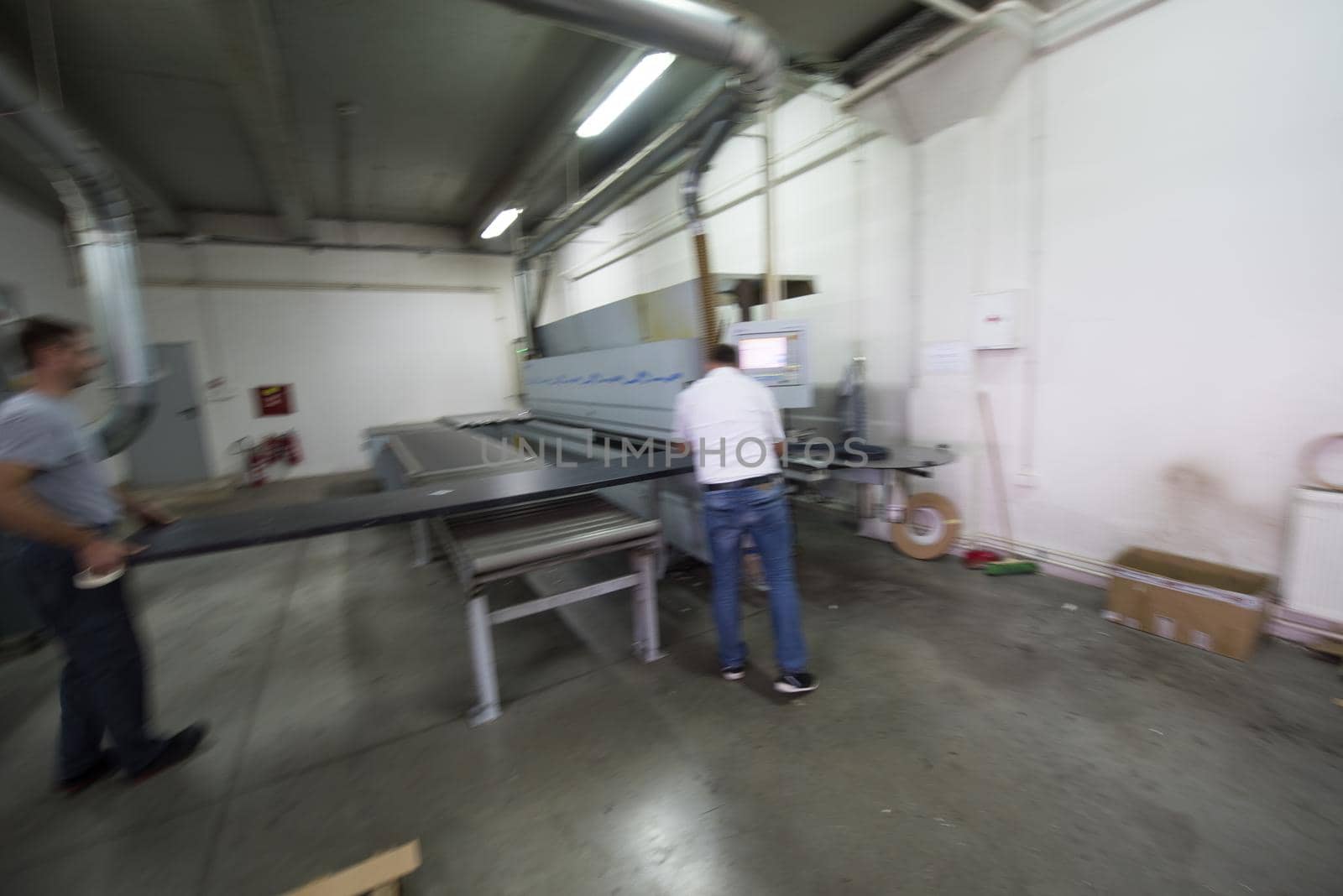 two worker working in a factory for the production of wooden furniture