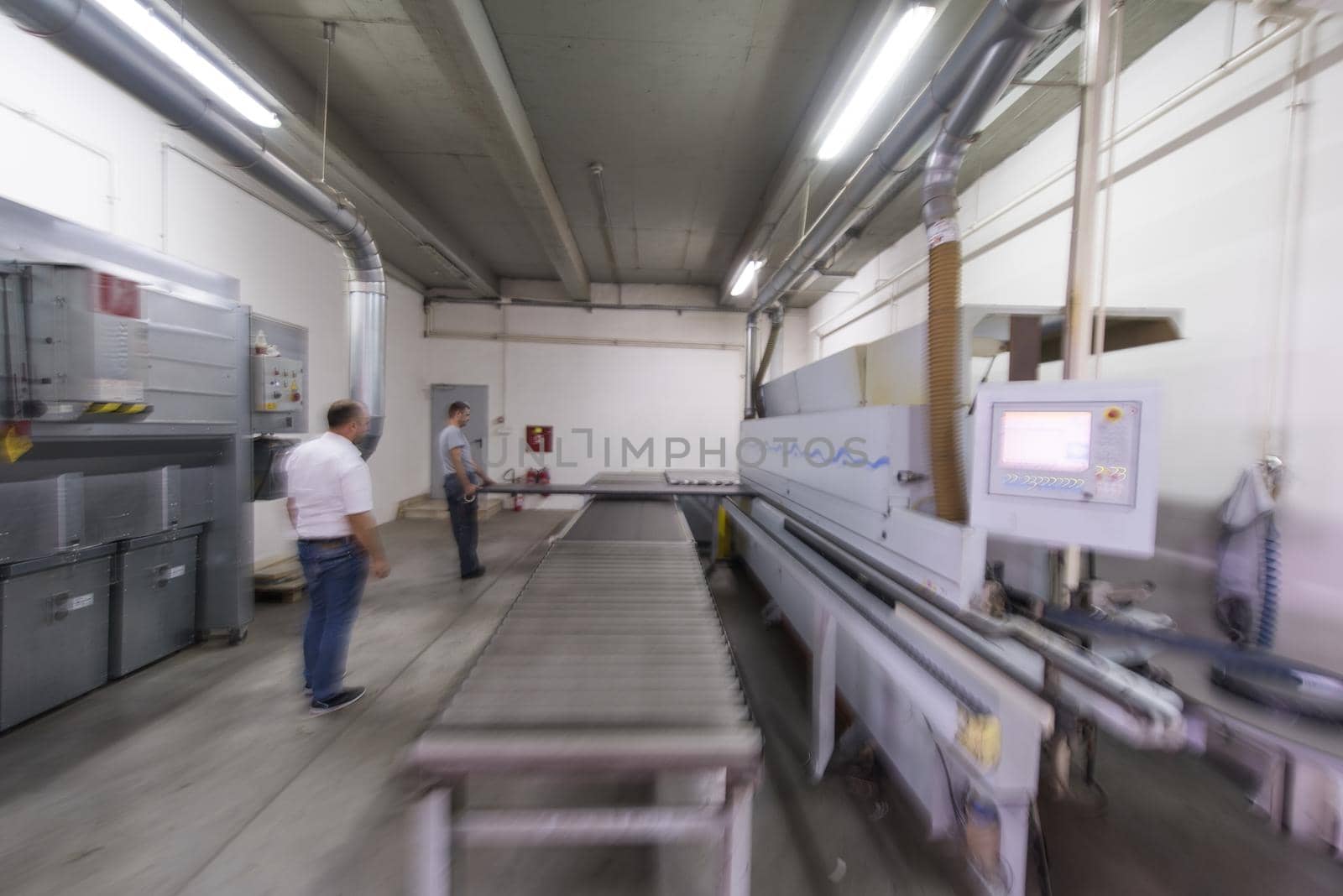 two worker working in a factory for the production of wooden furniture