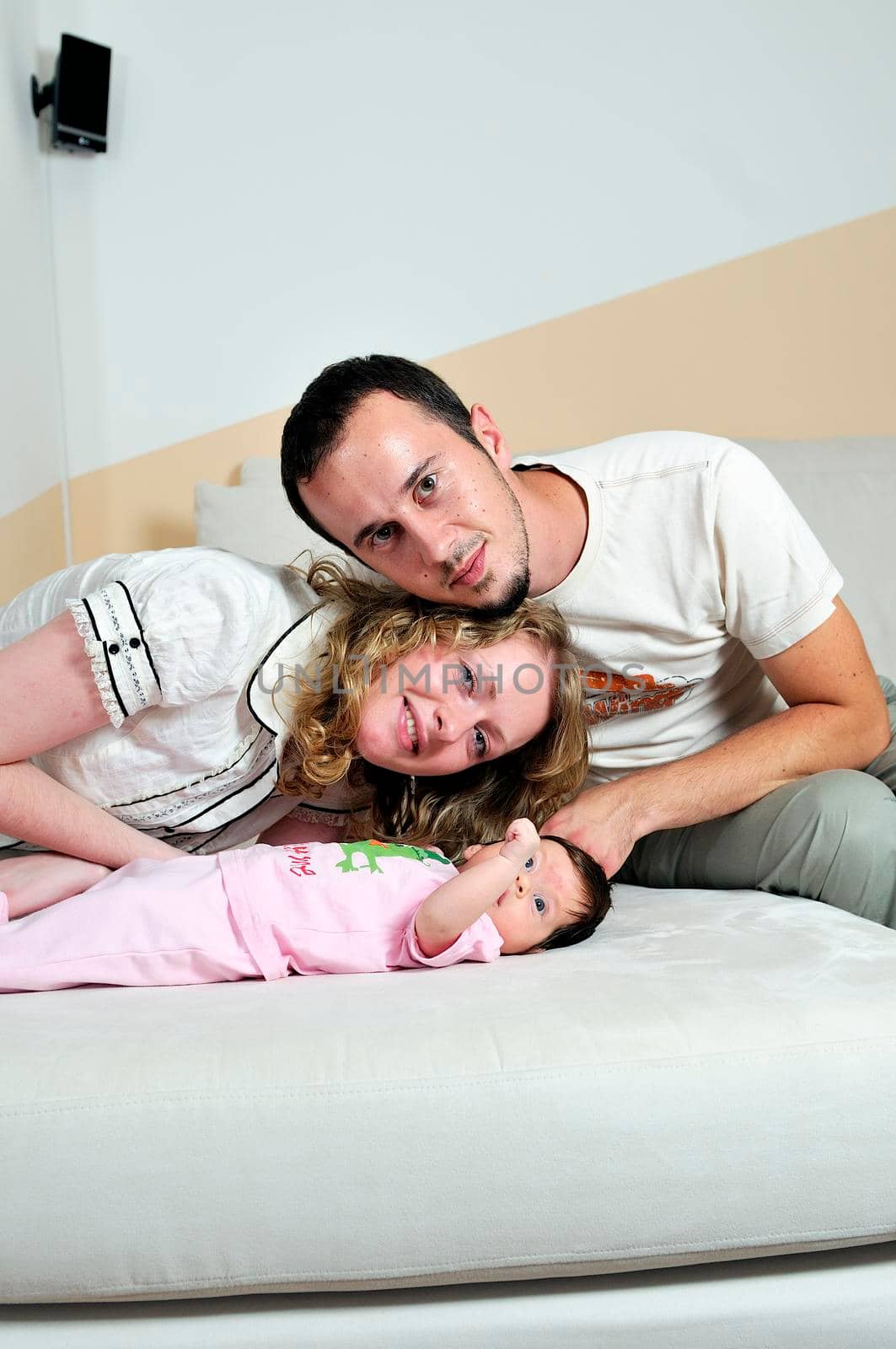 indoor portrait with happy young famil and  cute little babby 
