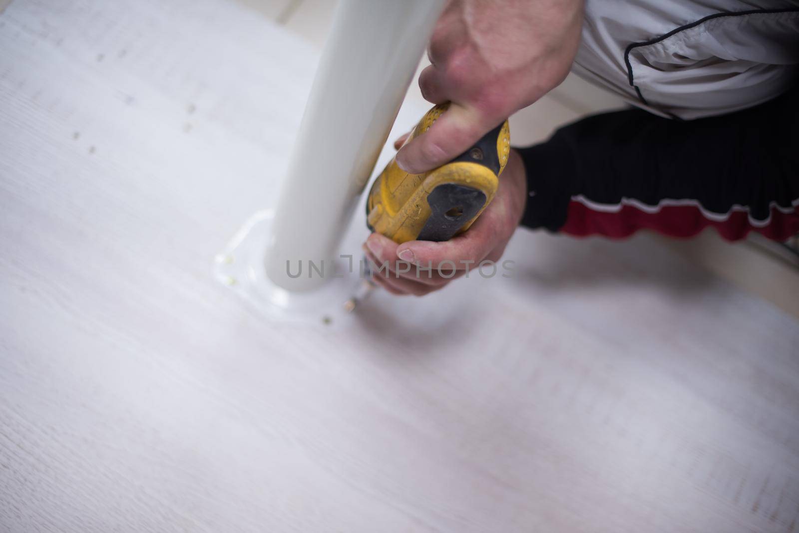 repairman working with drilling machine and assambling  furniture