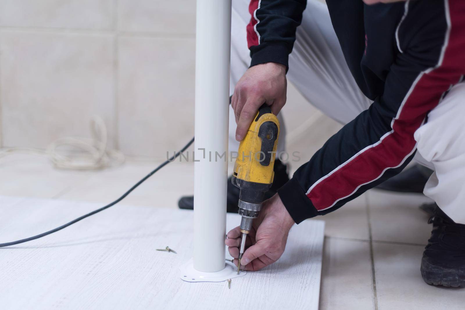 repairman working with drilling machine by dotshock