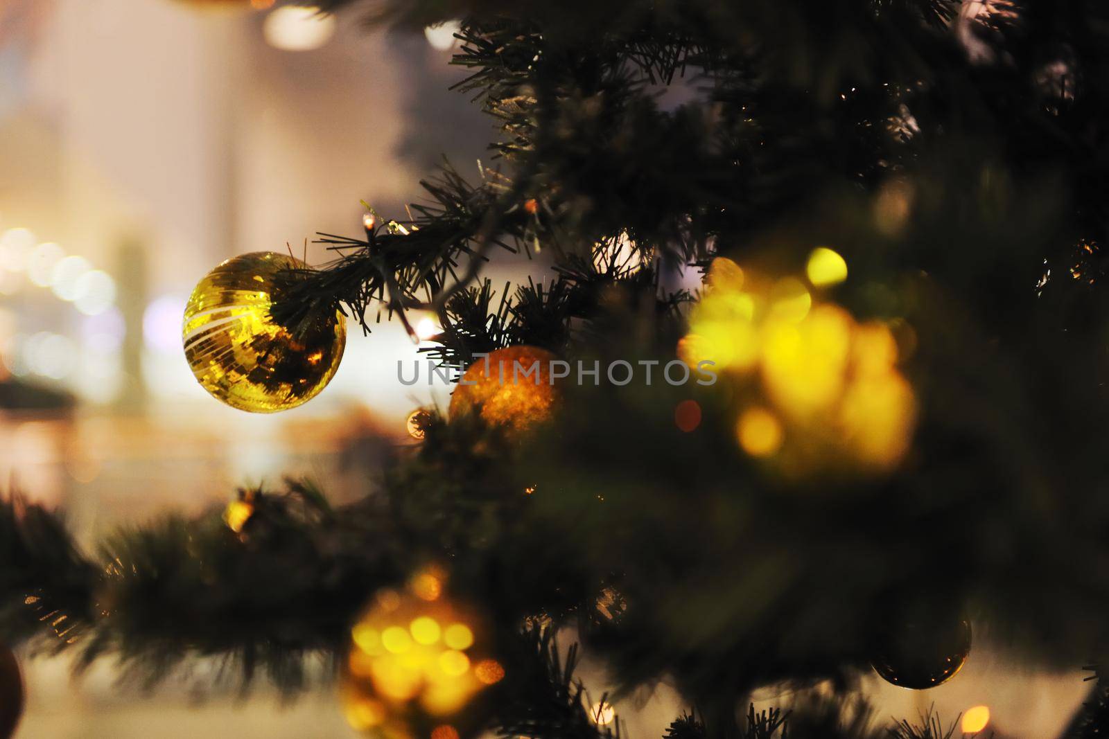 xmas tree decoration closeup with blured lights in shopping centre in backgroun