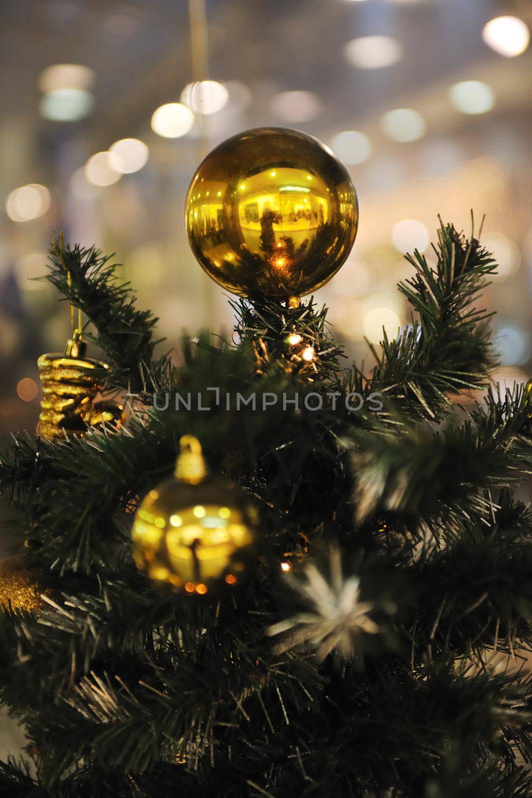xmas tree decoration closeup with blured lights in shopping centre in backgroun