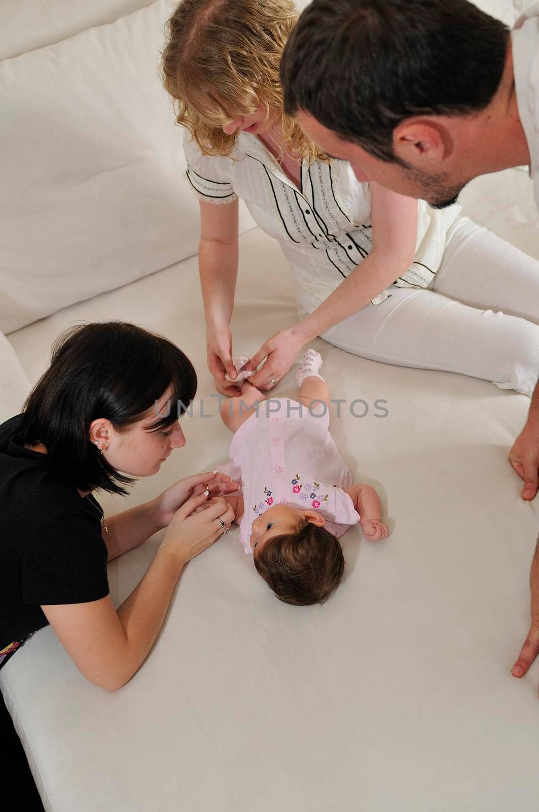 young family playing with cute little baby