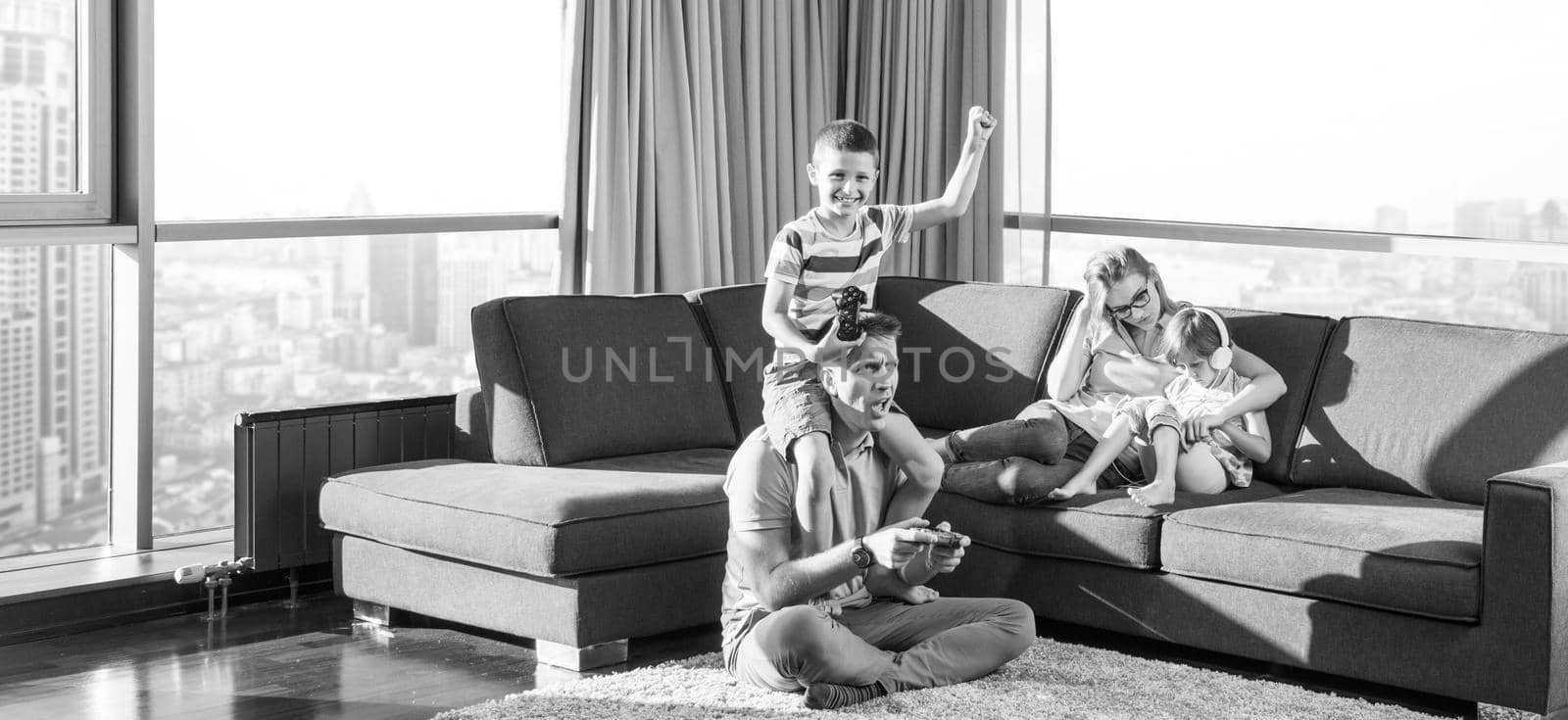 Happy family. Father, mother and children playing a video game Father and son playing video games together on the floor