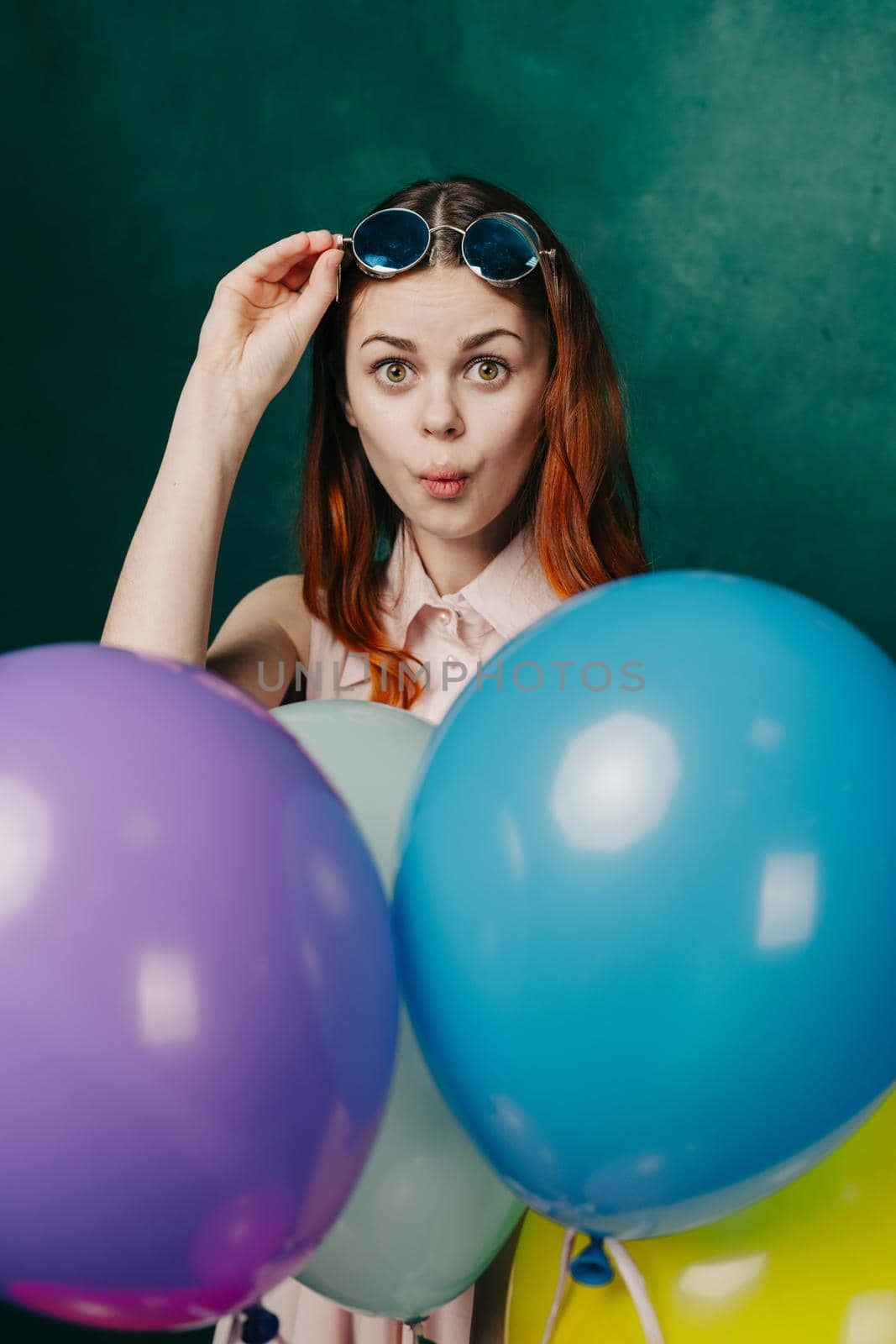 woman wearing fashionable glasses balloons holiday entertainment. High quality photo