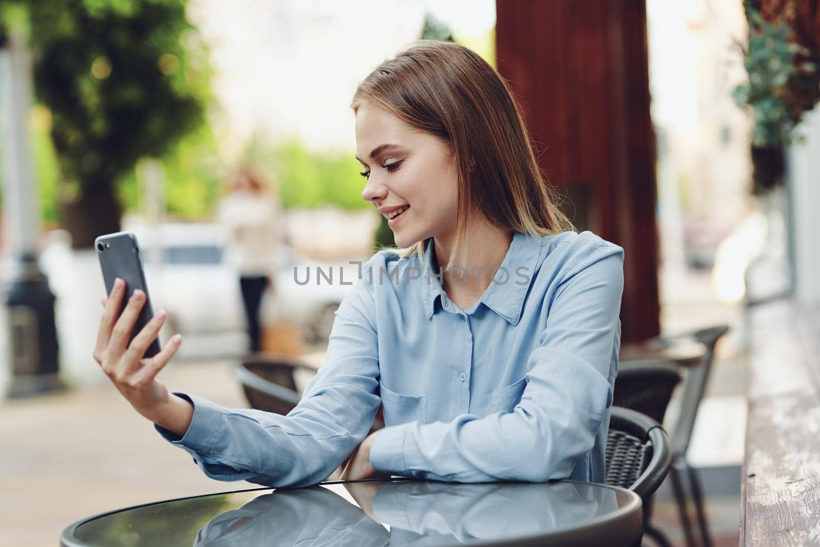 Business woman in a cafe in the summer outdoors on vacation. High quality photo