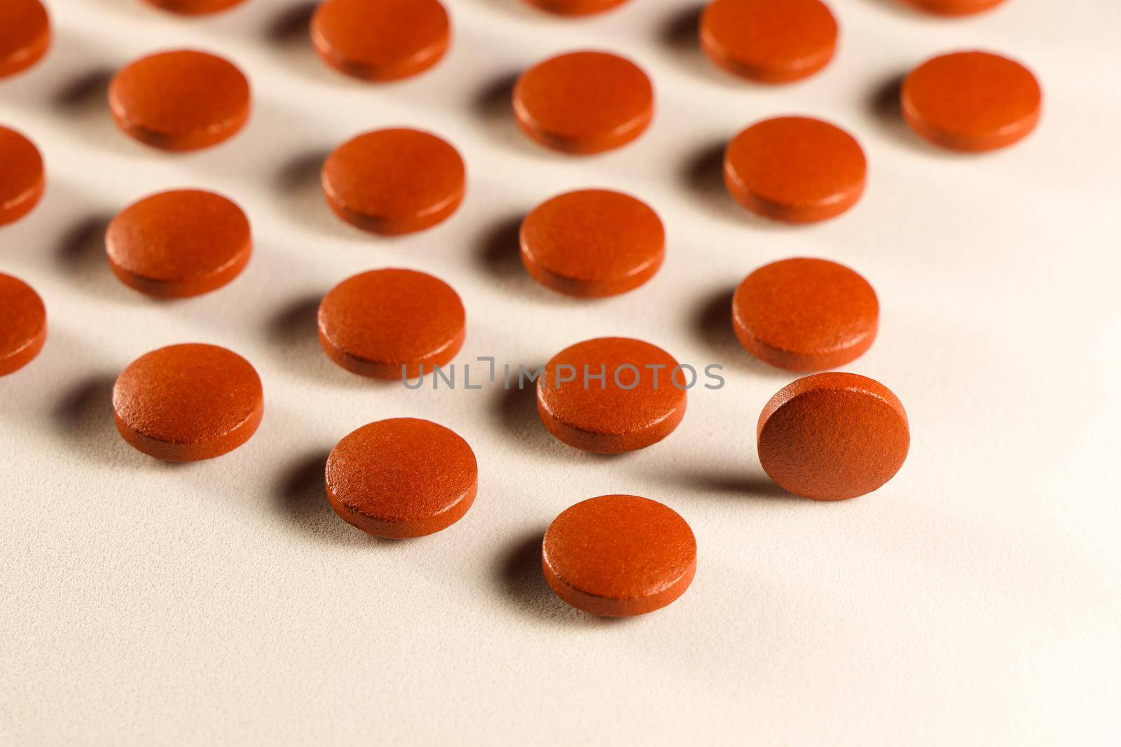 Round prescription pills abstract pattern layout close-up on white surface