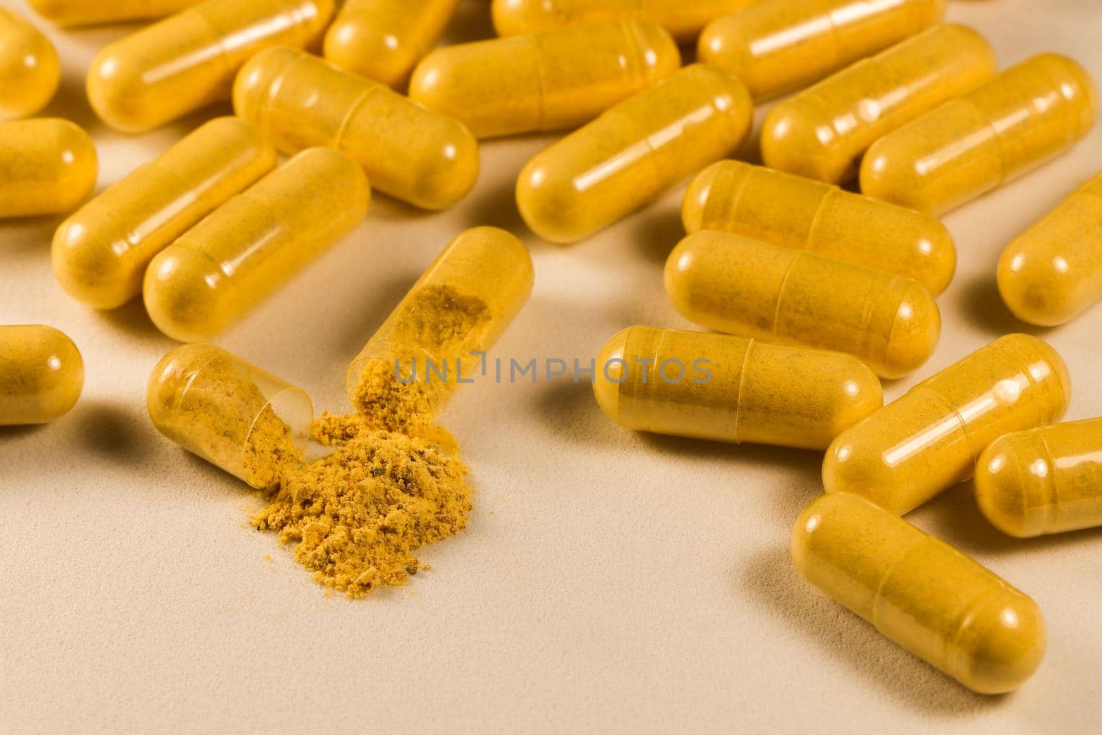 Supplement Drug Capsules With Powder On White Surface Close-up by jjvanginkel