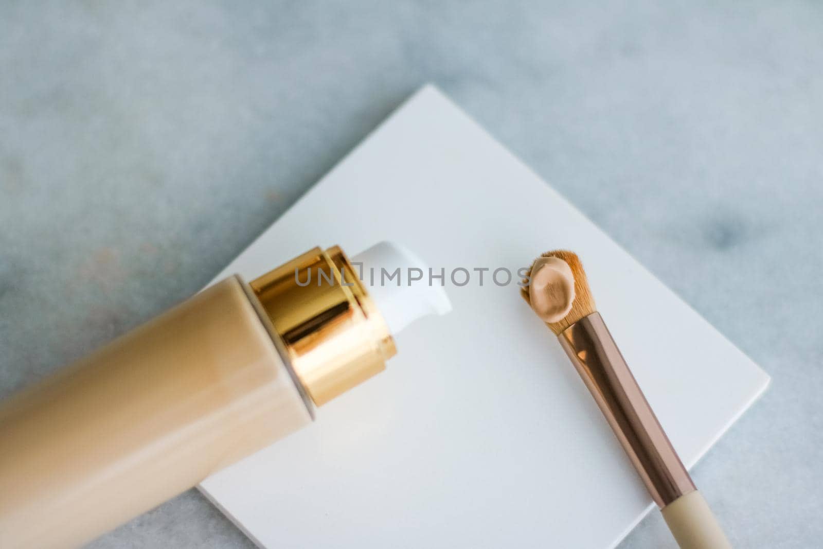 Cosmetic branding, glamour and skincare concept - Makeup foundation bottle and contouring brush on marble, make-up concealer bb cream as cosmetics product for luxury beauty brand holiday design