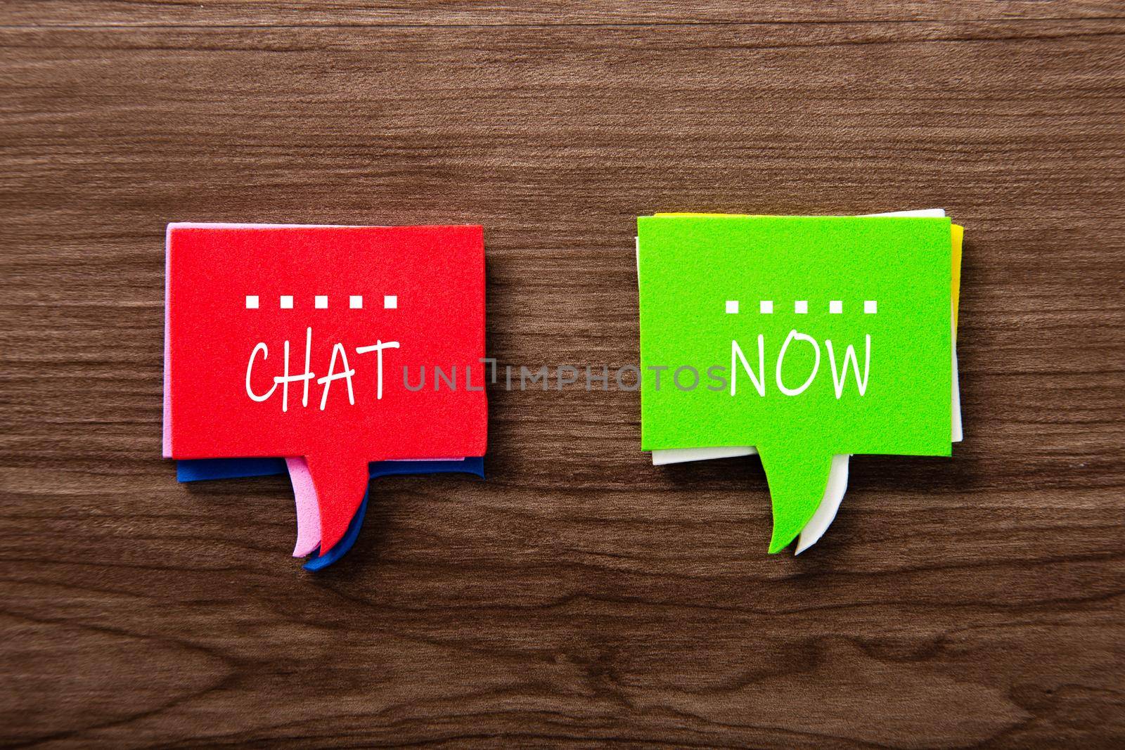 Bubble speech with word CHAT NOW on wooden background