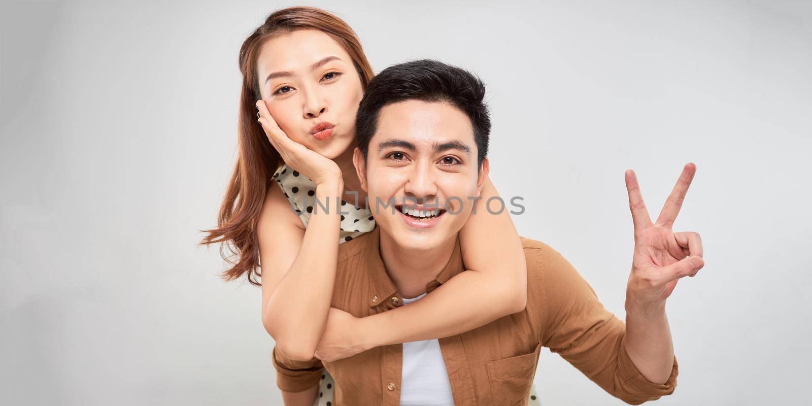 Loving couple. Beautiful loving couple having fun while standing isolated on white