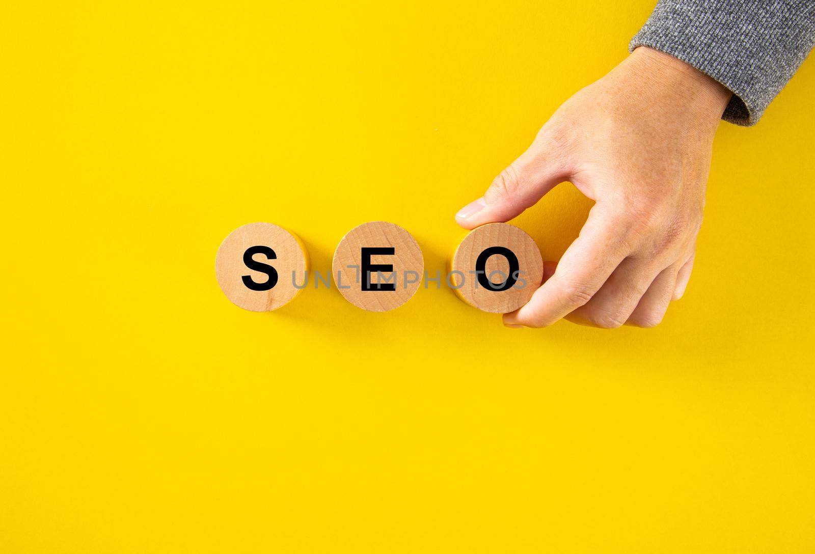 SEO (Search Engine Optimization) text wooden cube blocks on yellow  by tehcheesiong