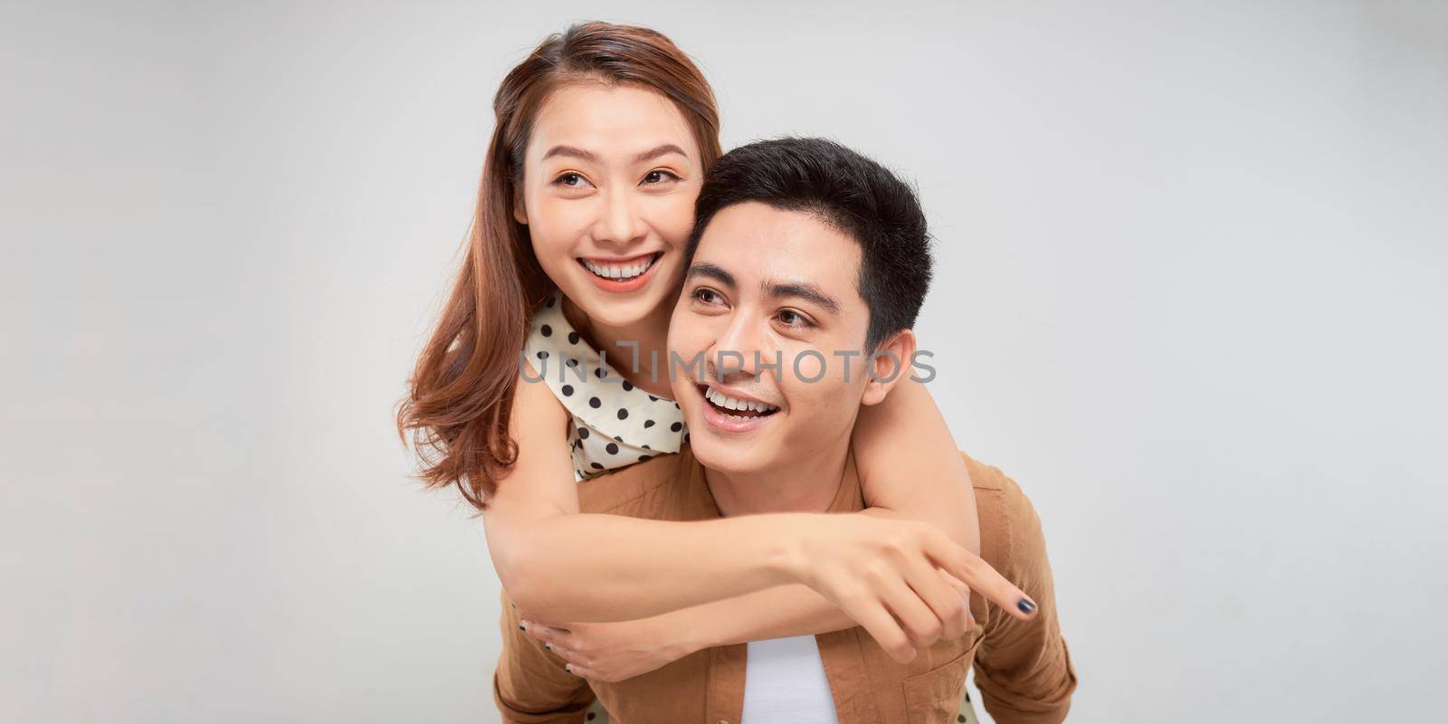 Loving couple. Beautiful loving couple having fun while standing isolated on white