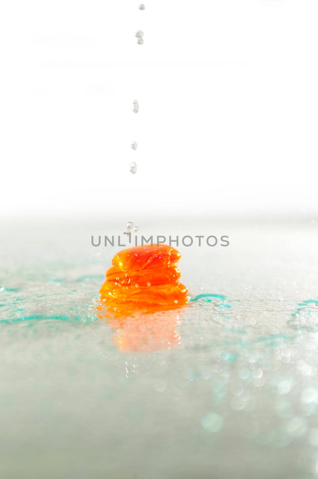 isolated wet zen stones with splashing  water drops   by dotshock