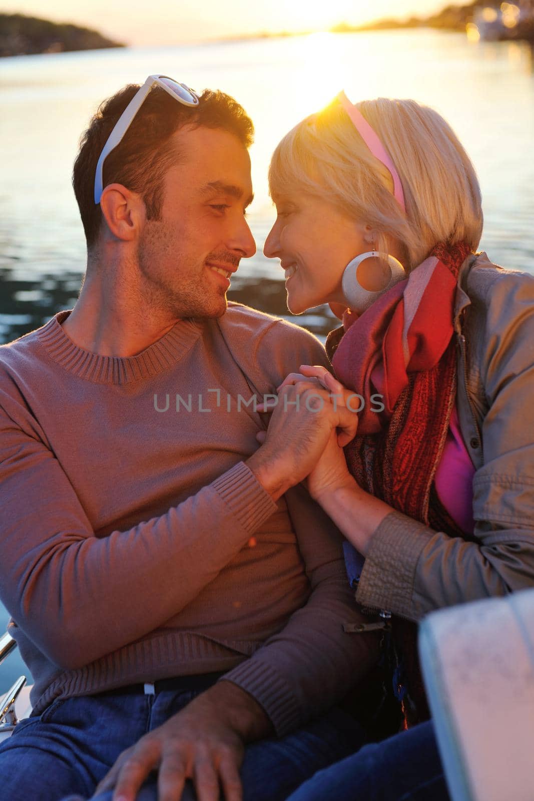 happy young couple in love  have romantic time at summer sunset   at ship boat while  representing urban and countryside fashin lifestyle