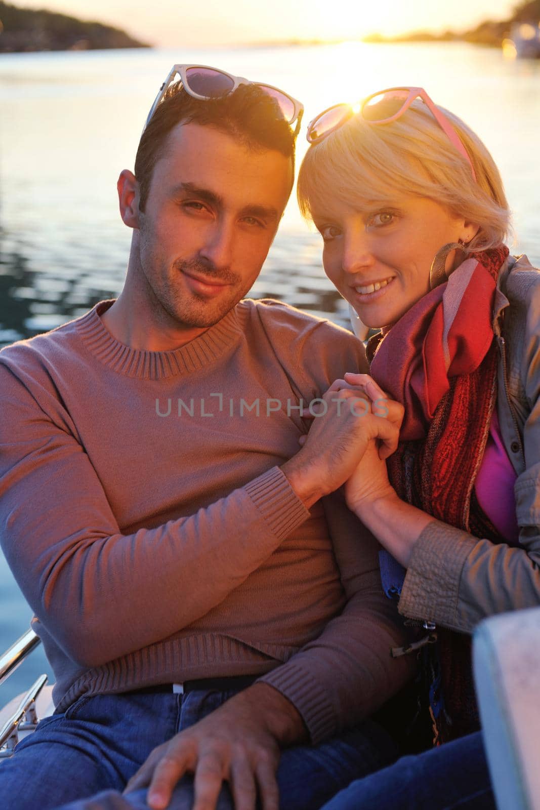 happy young couple in love  have romantic time at summer sunset   at ship boat while  representing urban and countryside fashin lifestyle