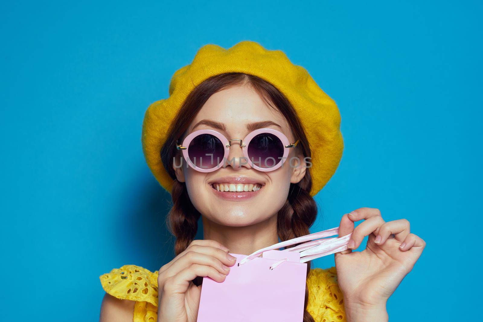 smiling woman in a yellow hat Shopaholic fashion style isolated background. High quality photo