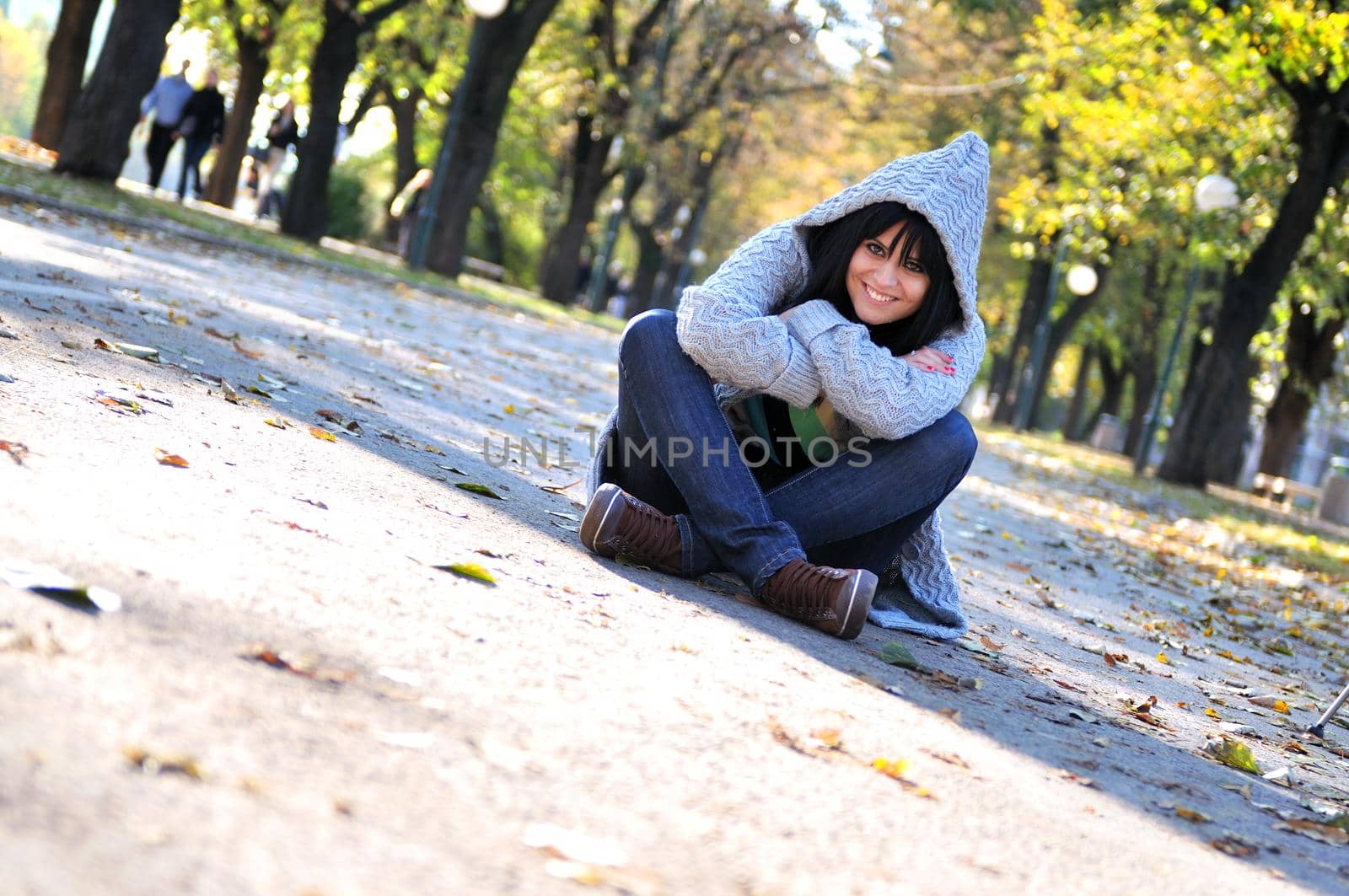 Cute young woman smiling outdoors in nature by dotshock