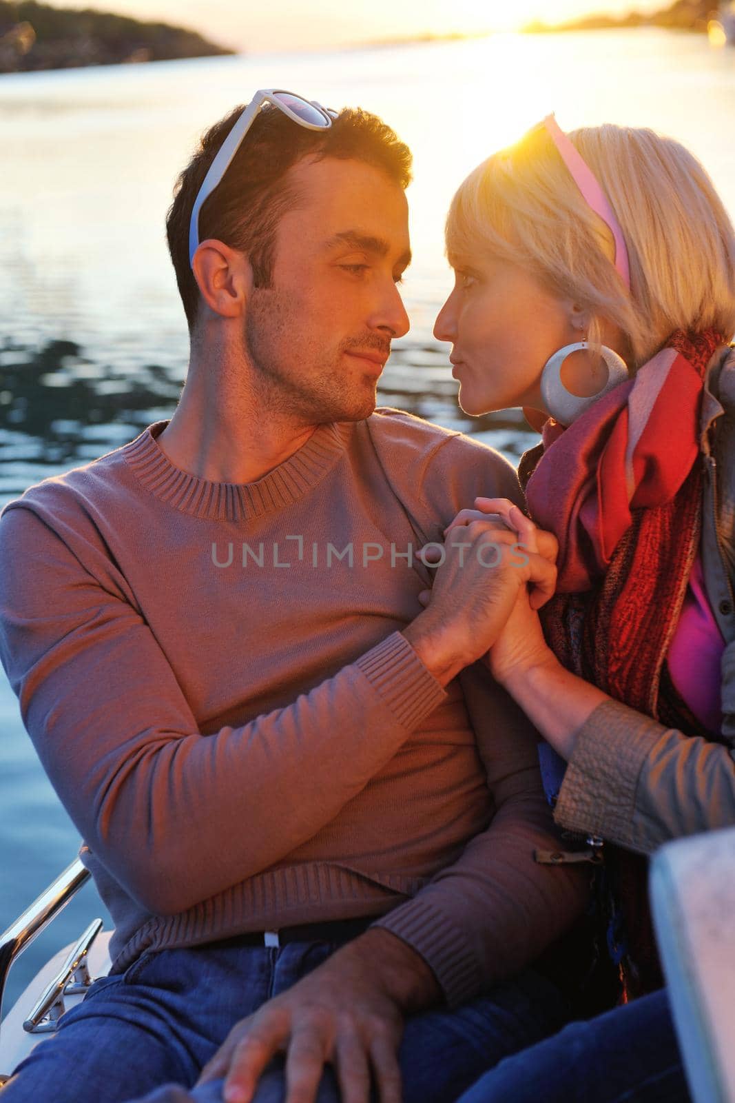 happy young couple in love  have romantic time at summer sunset   at ship boat while  representing urban and countryside fashin lifestyle