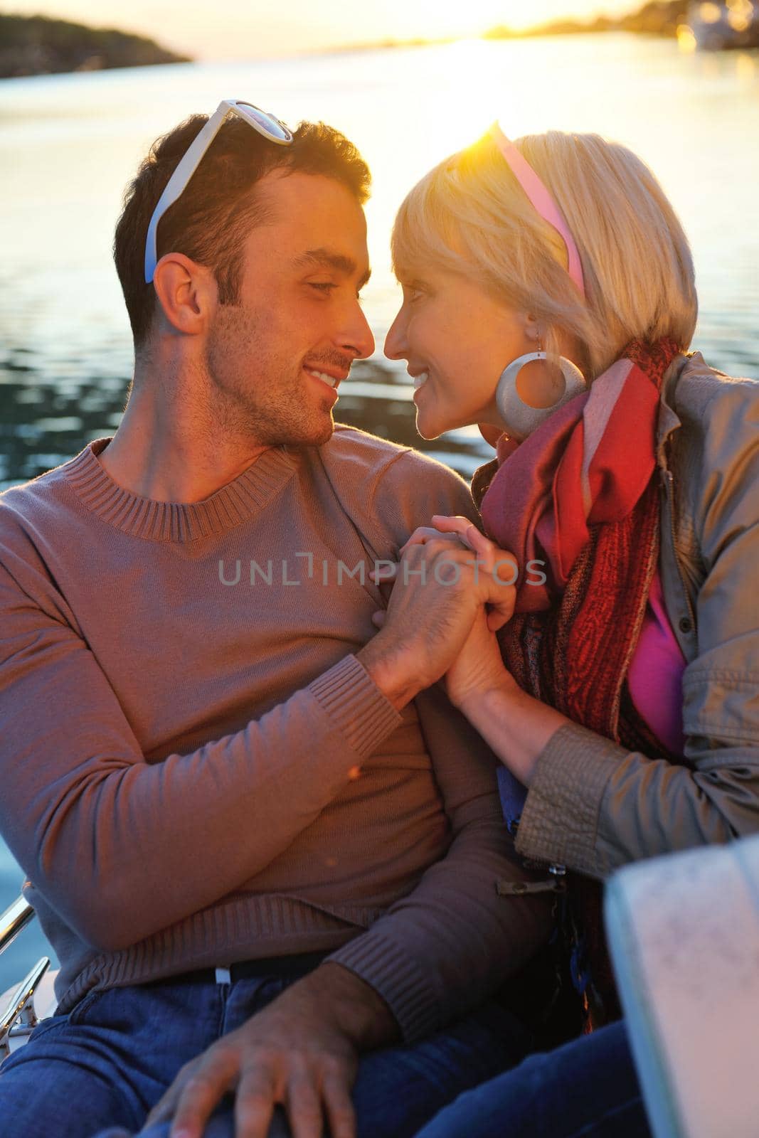 happy young couple in love  have romantic time at summer sunset   at ship boat while  representing urban and countryside fashin lifestyle