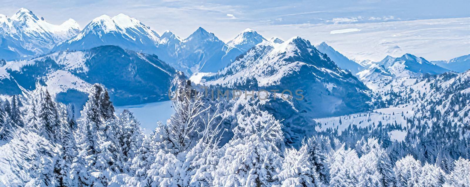 Winter wonderland and magical Christmas landscape. Snowy mountains and forest covered with snow as holiday background.
