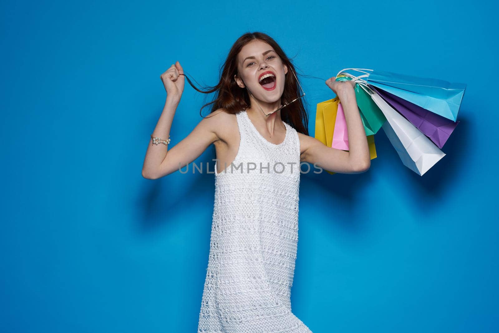 smiling woman with packages in hands Shopaholic isolated background. High quality photo