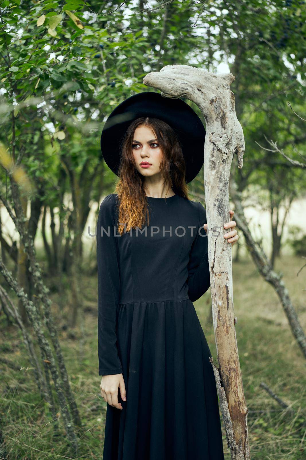 woman in black suit Witch in a fantasy forest by Vichizh