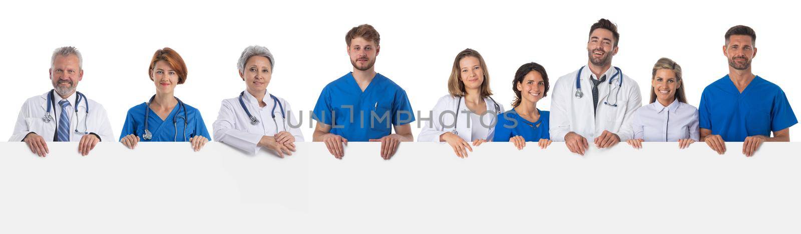 Medical doctor team with blank billboard by ALotOfPeople