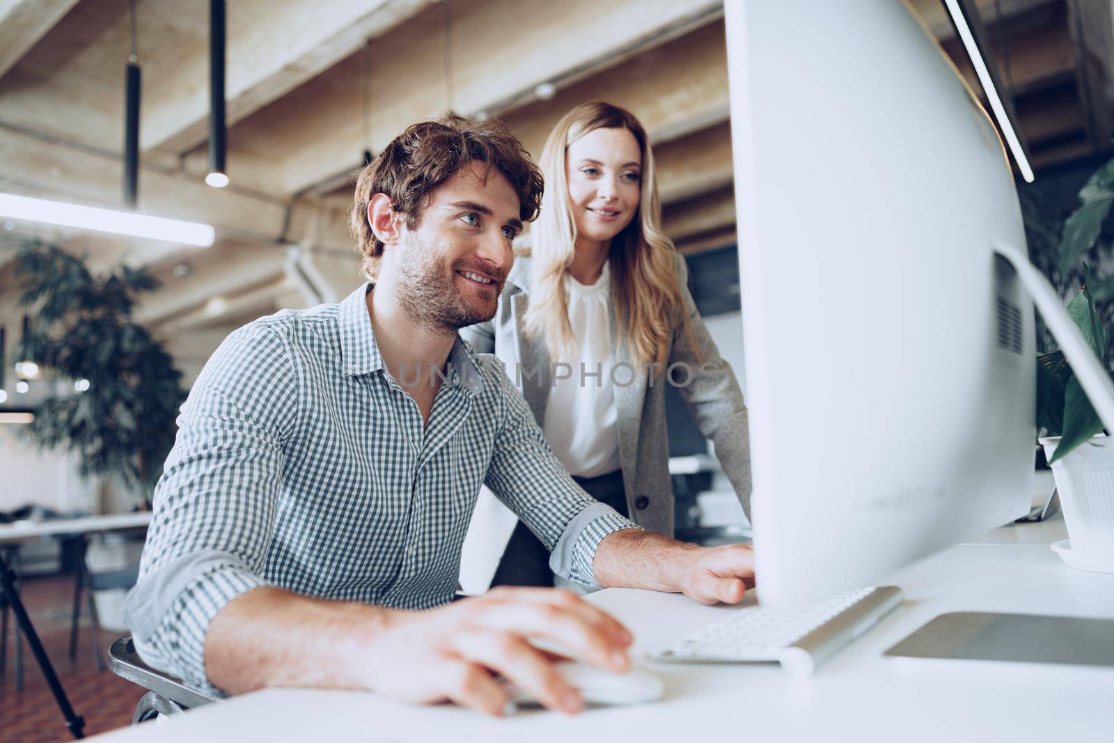 Young business people working together on project in modern office close up