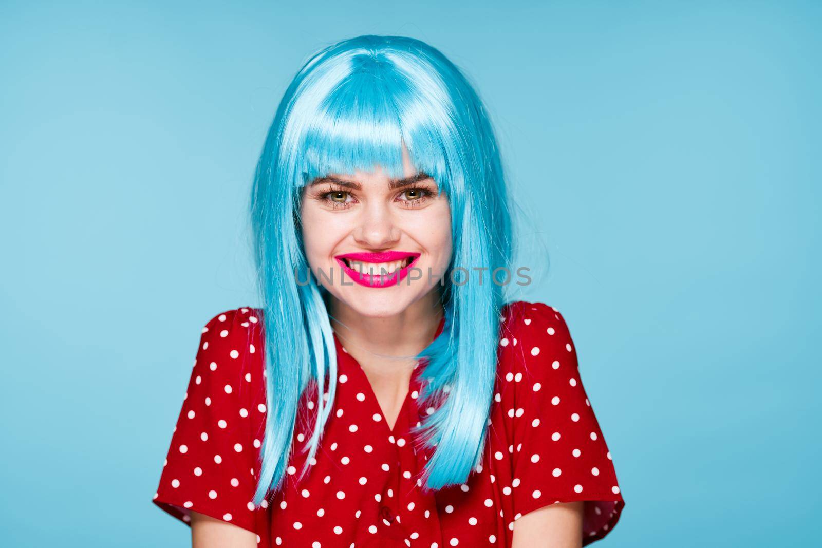 emotional woman in red dress blue wig red lips fashion. High quality photo