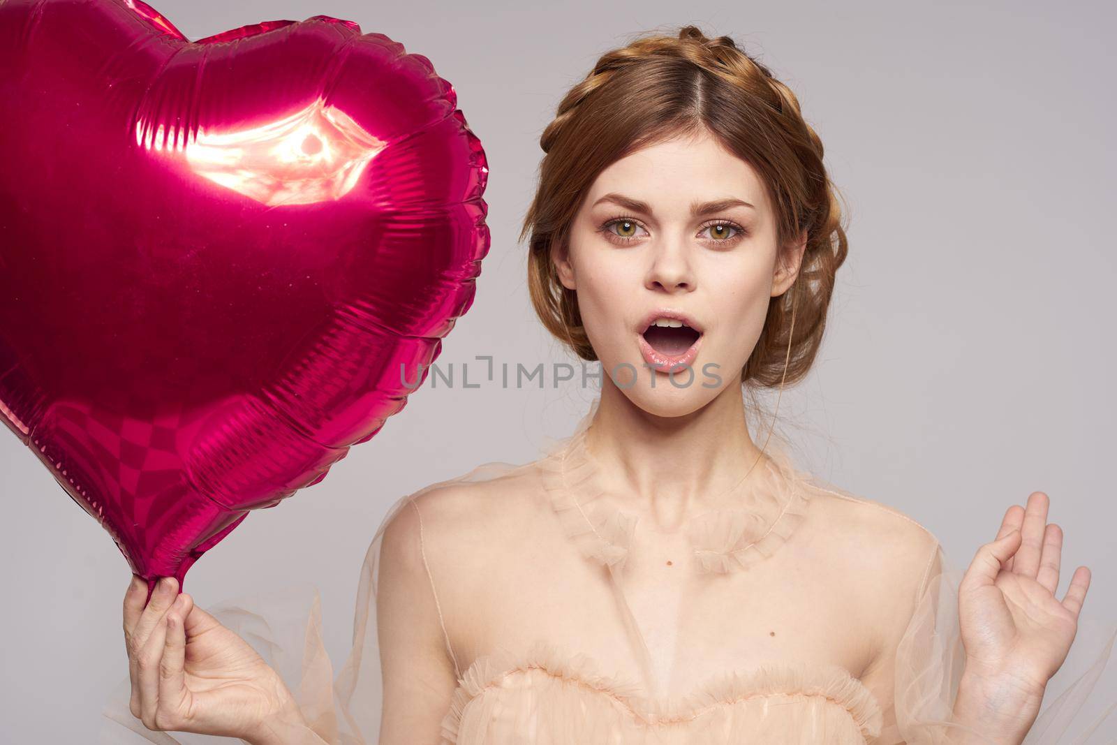 portrait of a woman in a dress balloon Valentine's Day model studio. High quality photo