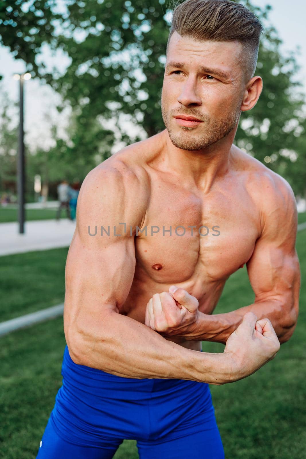 sporty muscled man with naked torso in a workout park. High quality photo