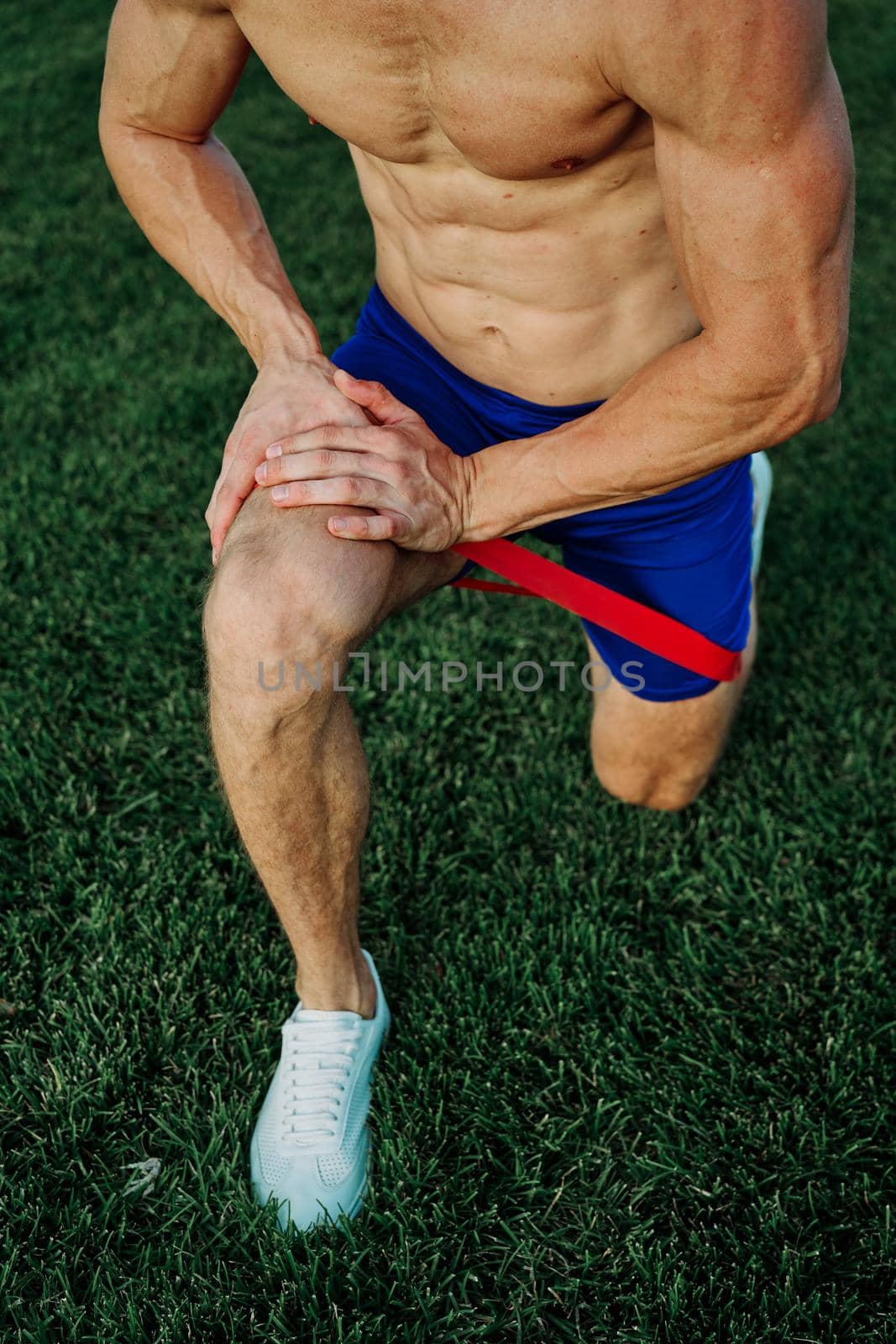 athletic man working out in the park crossfit exercise. High quality photo