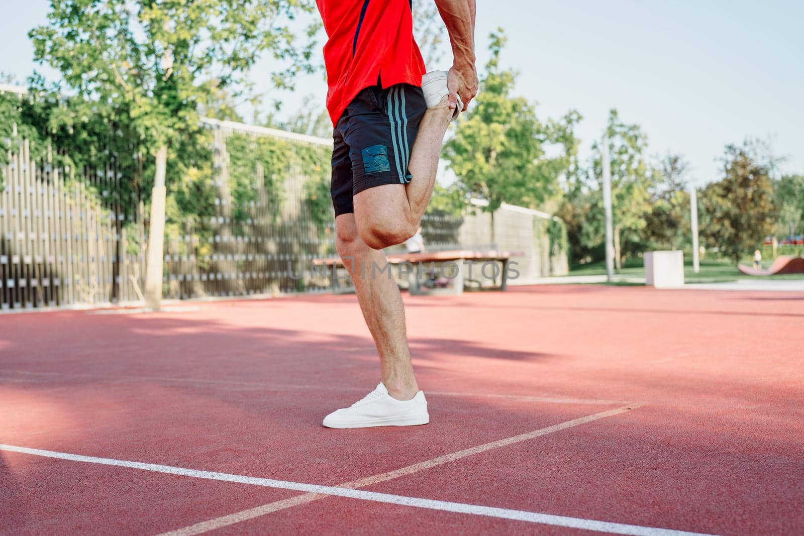 athletic man on sports ground workout exercise crossfit summer. High quality photo