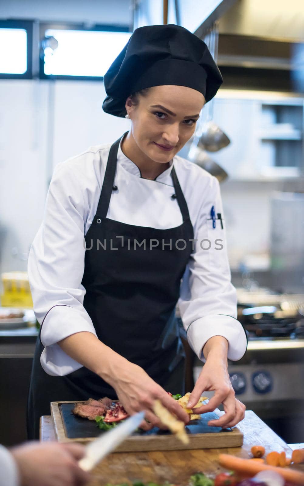 female Chef preparing beef steak by dotshock