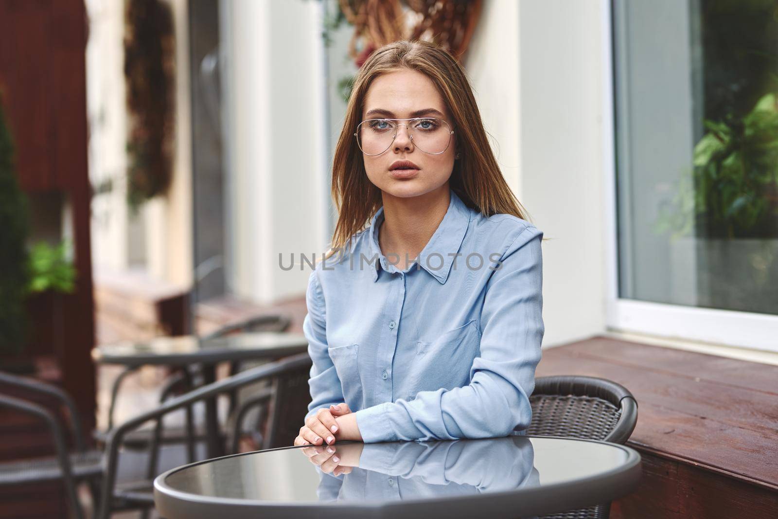 Business woman in a cafe outdoors fresh air summer. High quality photo