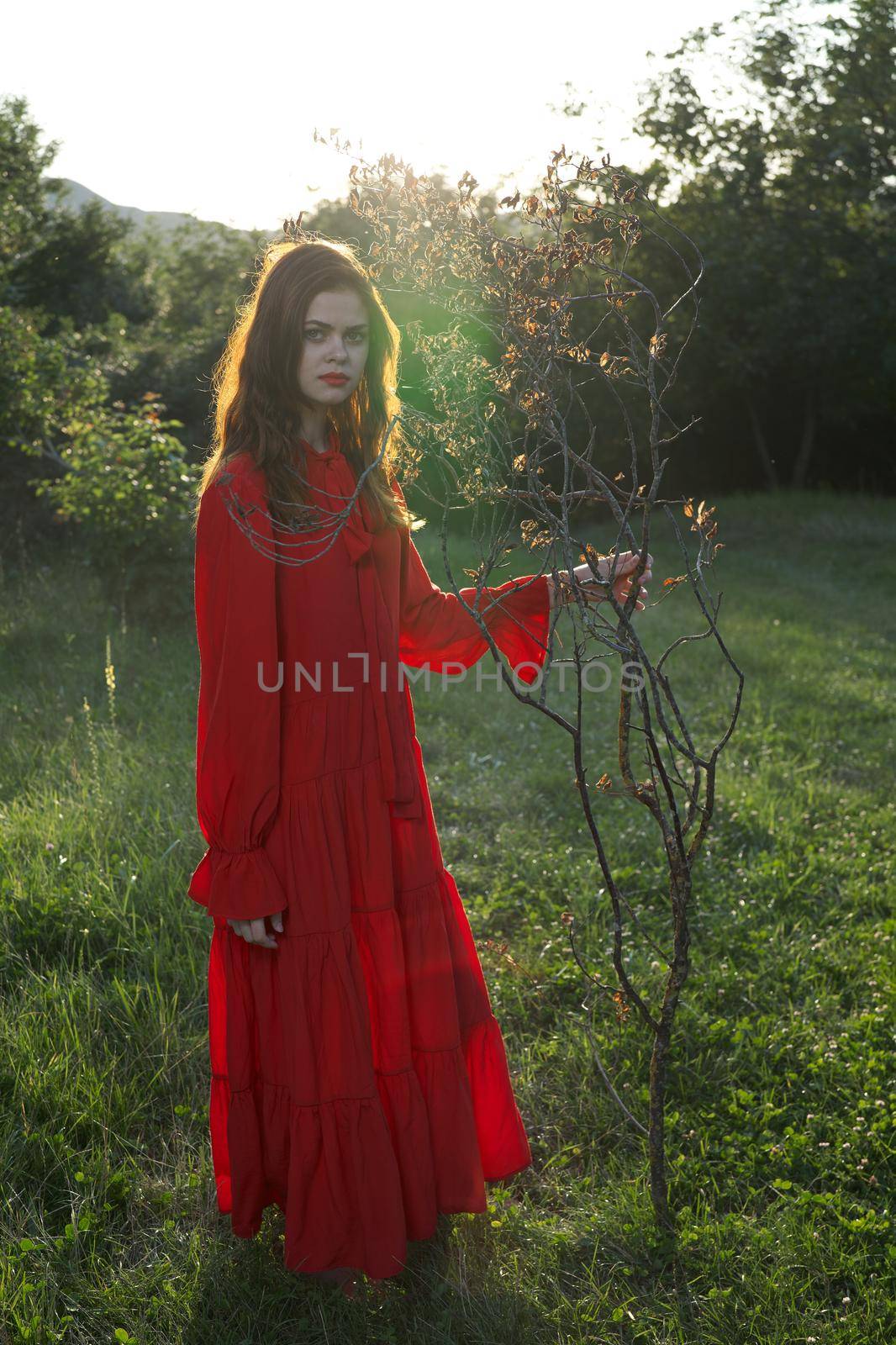 attractive woman in red dress outdoors fresh air summer. High quality photo