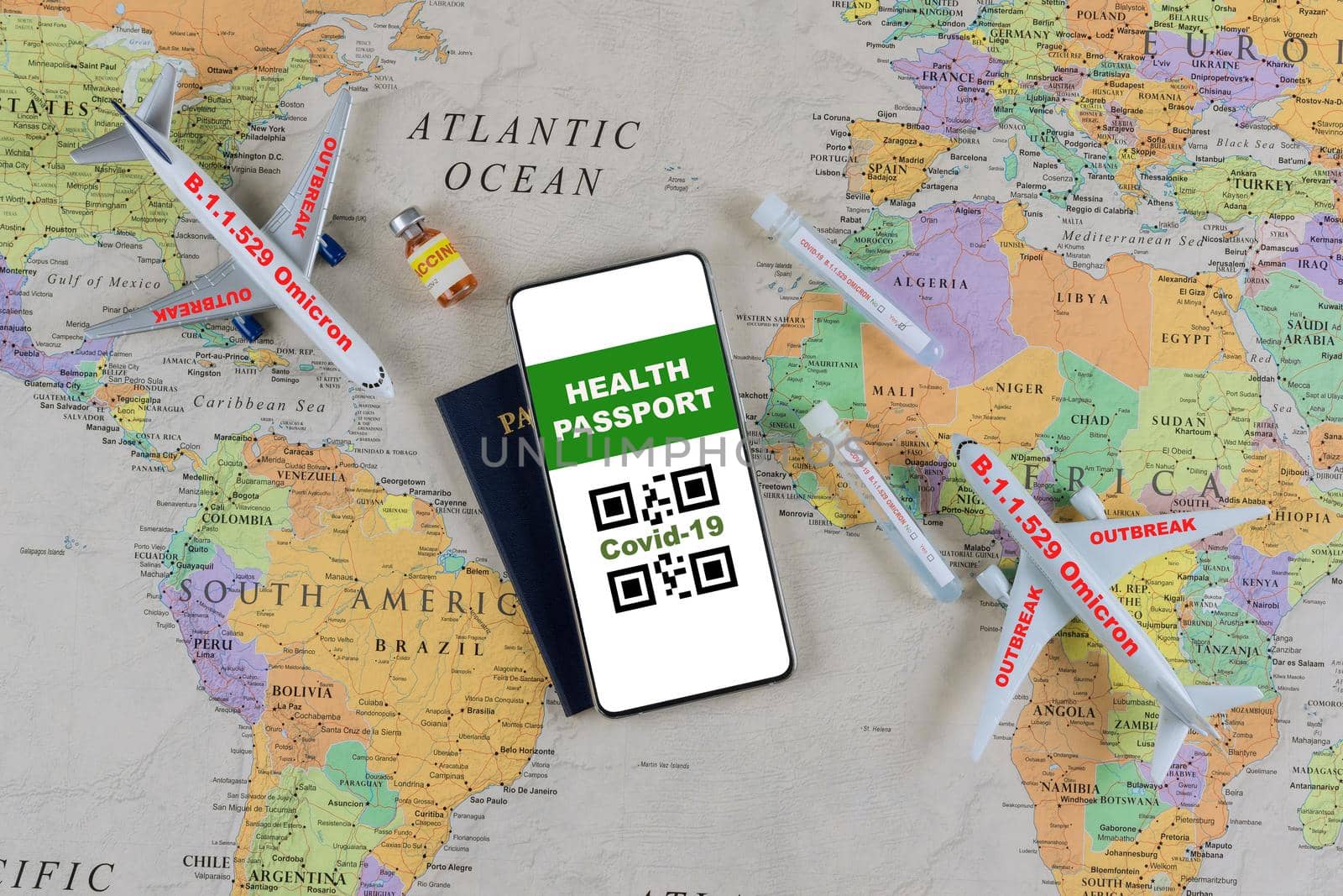 Smartphone with a digital of Covid-19 health vaccination passport a tube containing a swab sample for new mutation coronavirus Omicron by ungvar
