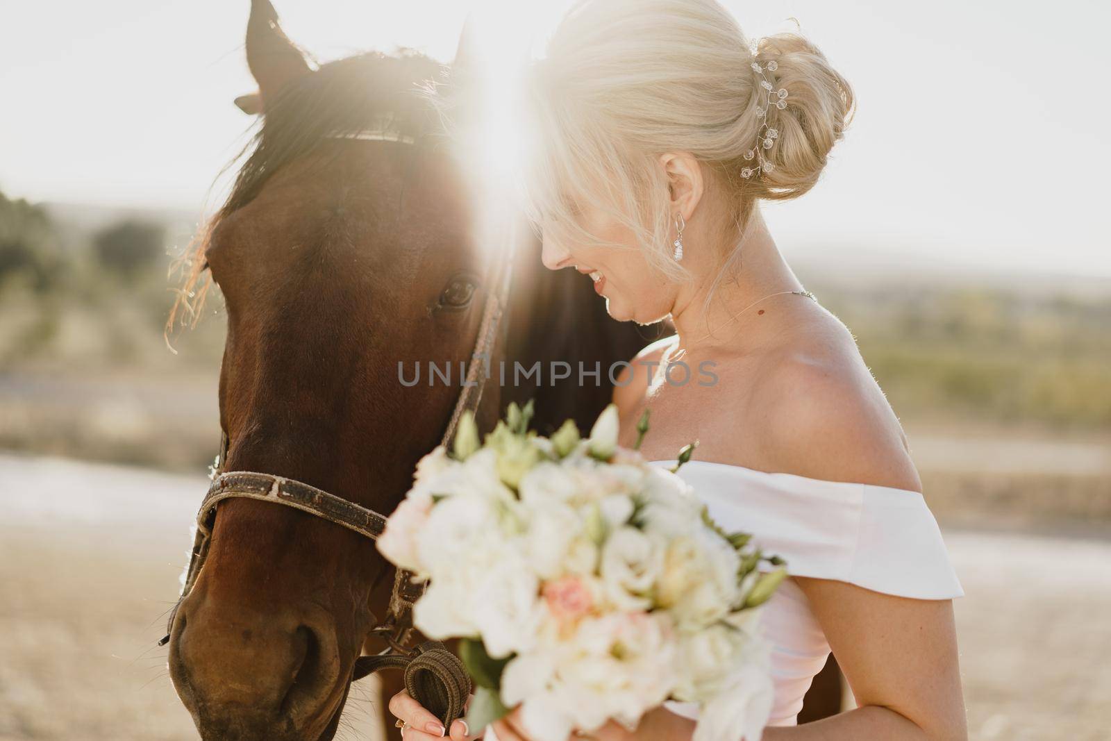 Portrait of a beautiful bride standing with horse