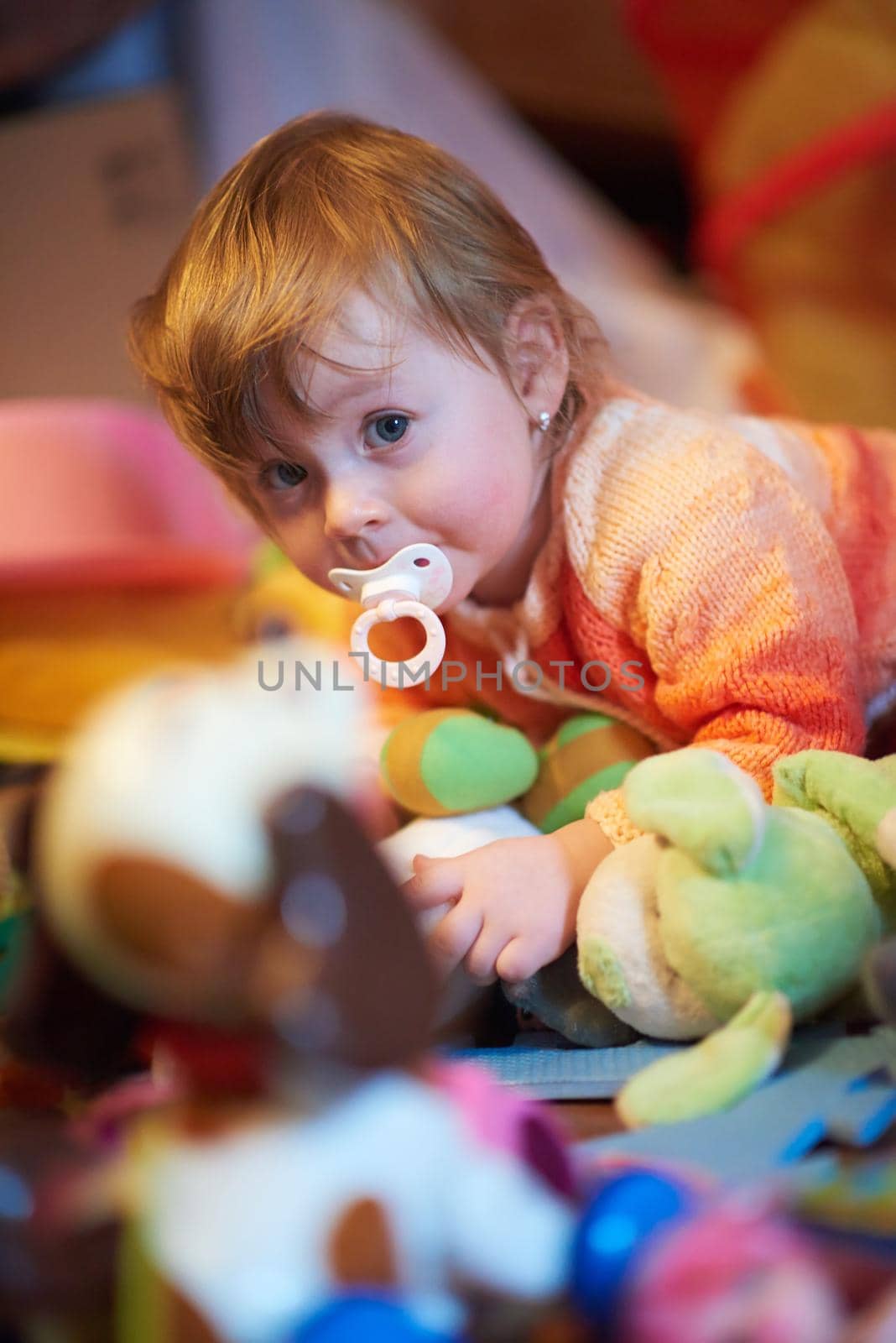 cute little child baby girl  playing with toys at home