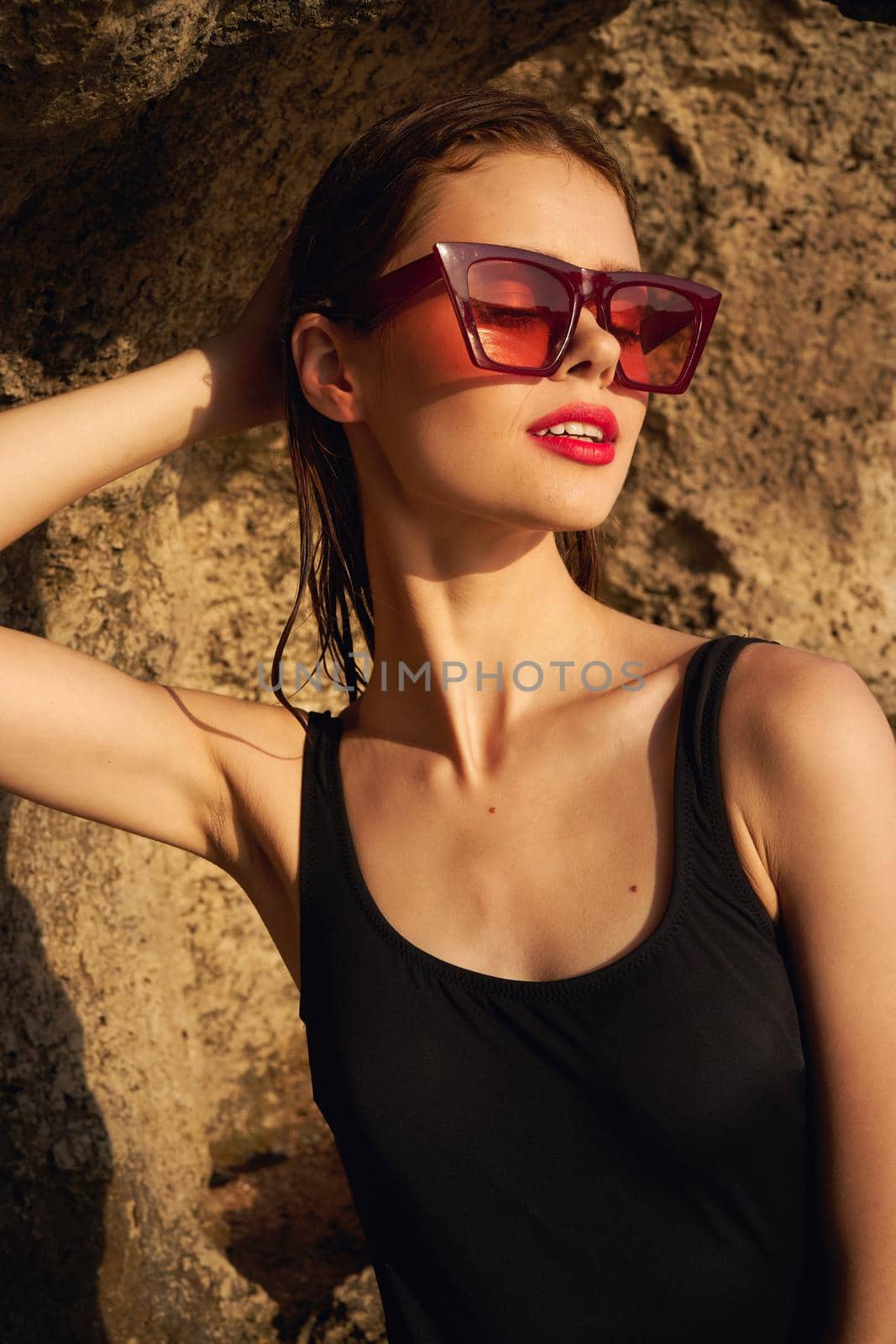 woman in black swimsuit summer posing rocks by Vichizh