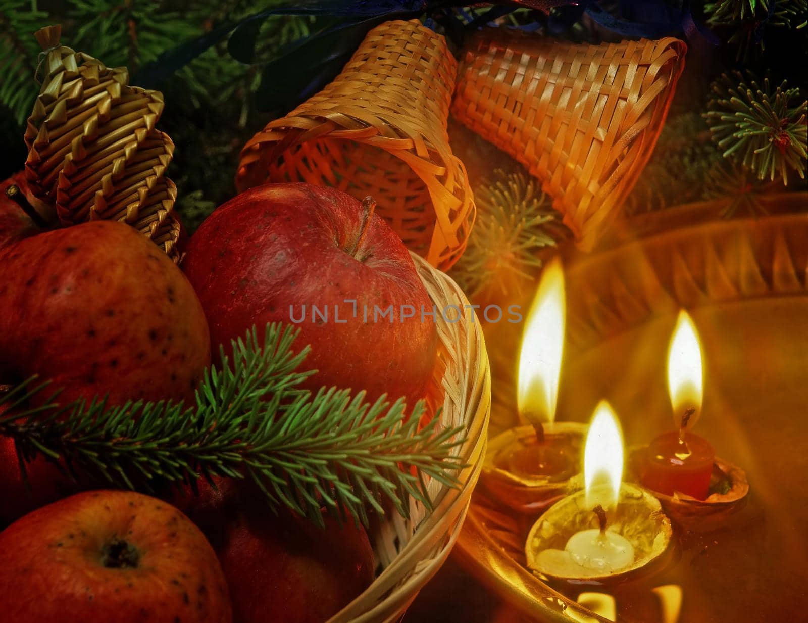 christmas still life with an apples and candles floating in plate