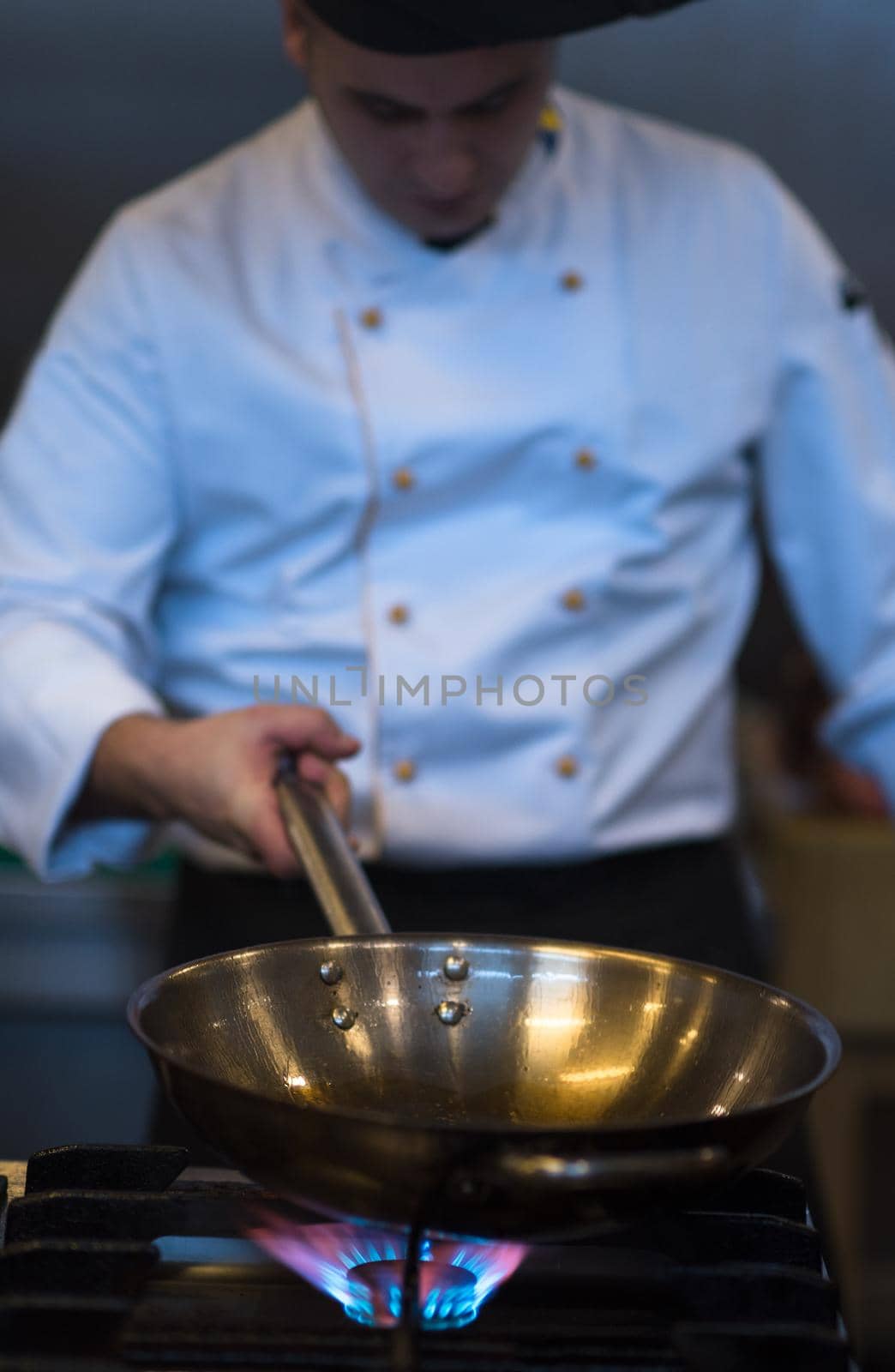 Master chef preparing food, frying in wok pan. Sale and food concept